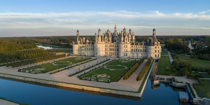 An aerial view of the Loire Valley's Château de Chambord showcases its intricate architecture and expansive gardens.