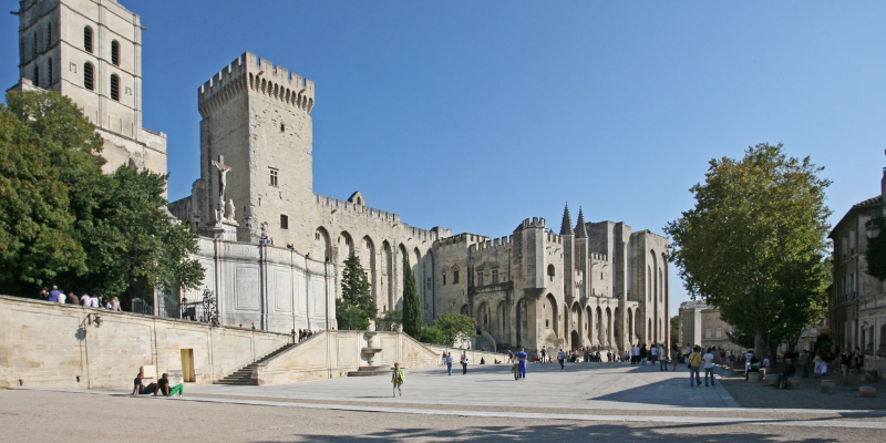 View of the historic Palais des Papes in Avignon, France, reflects the historical significance of the papacy in medieval Europe.