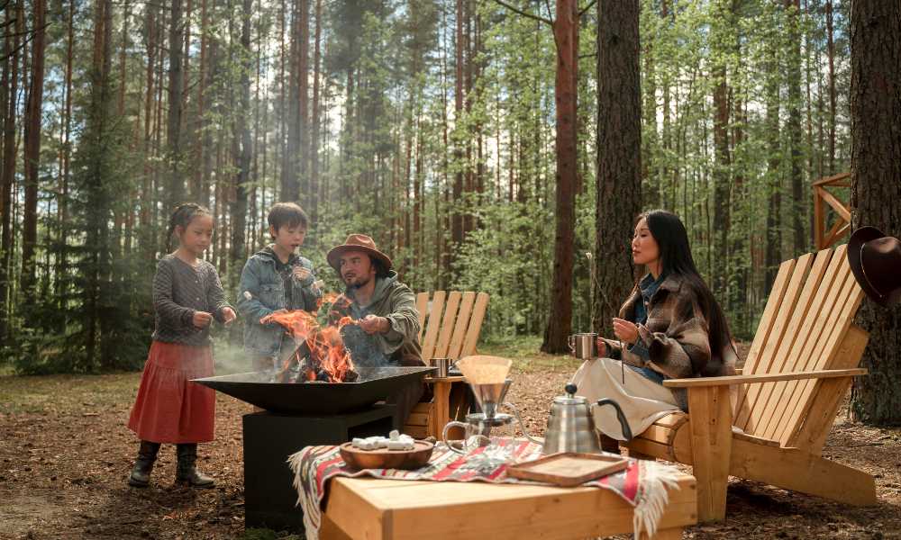 A joyful family sitting by a campfire in Ocala National Forest, creating memories and enjoying each other's company.