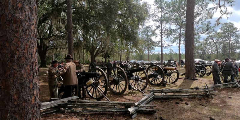 At the Battle of Olustee Historic Site reenactors engage in a historical demonstration, wearing authentic uniforms and performing drills.