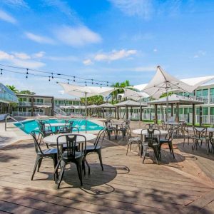 Pool area at the beach inn, complete with sun loungers and palm trees.