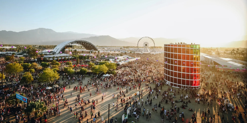 A large, diverse crowd celebrating at the Coachella Valley Music and Arts Festival, filled with energy and excitement.