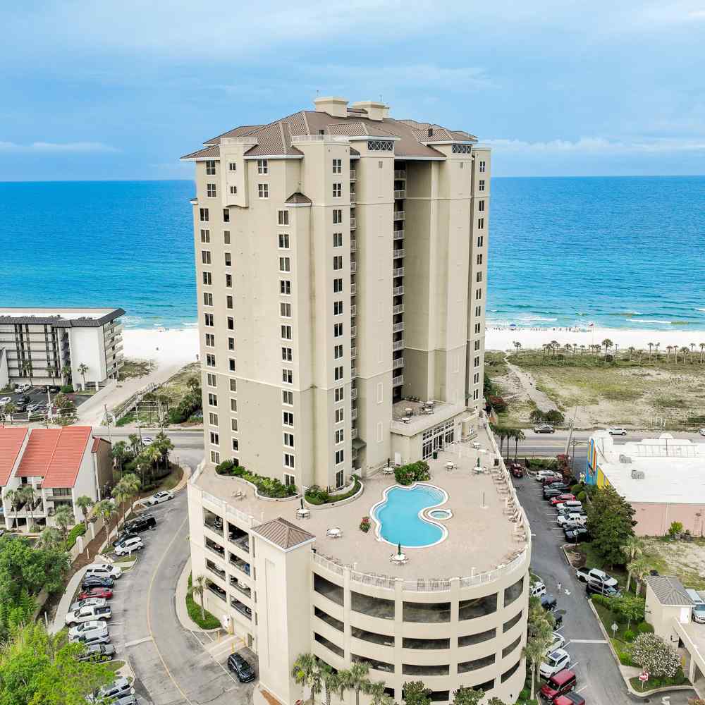 Aerial image of a beachfront condominium, emphasizing its stunning ocean views and surroundings.