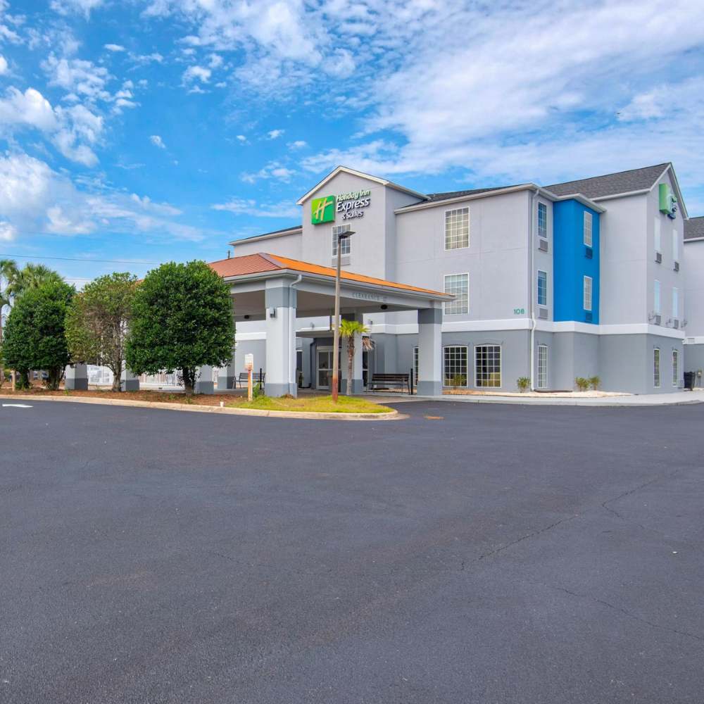 Exterior view of a Holiday Inn Express hotel with clear skies, suitable accommodation for visiting Destin Florida.