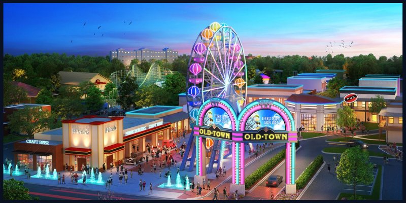 Colorful evening view of Old Town Kissimmee featuring a lit Ferris wheel and bustling street with visitors.