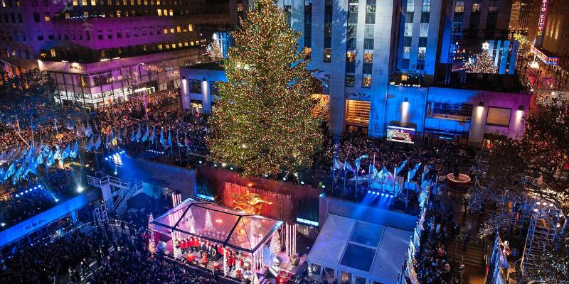 The Rockefeller Center Christmas tree shines brightly in New York City, adorned with festive lights and decorations.