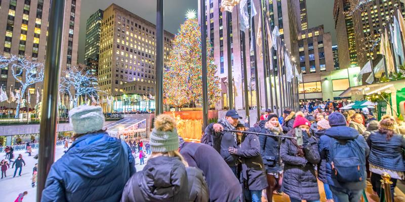 People gather around a beautifully decorated Christmas tree at Rockefeller Center in New York City.