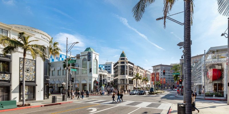 The iconic Hollywood sign overlooking the vibrant Rodeo Drive in California symbolizes the entertainment industry.