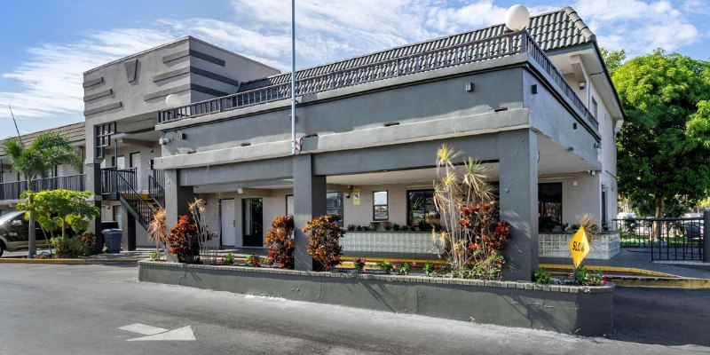 The stylish facade of a Clearwater hotel, featuring contemporary design elements and lush landscaping in a sunny setting.