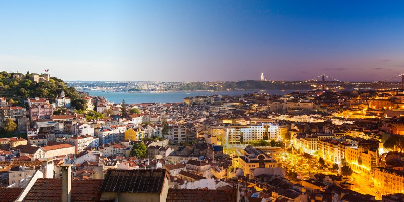 A panoramic view of San Francisco featuring the ocean and a prominent bridge in the skyline.