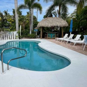 A tranquil pool area adorned with comfortable lounge chairs.