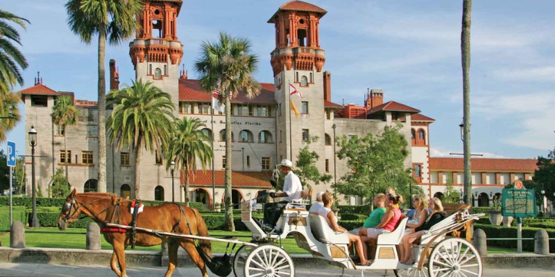 A horse-drawn carriage is parked in front of St. Augustine, showcasing a blend of elegance and historical charm.