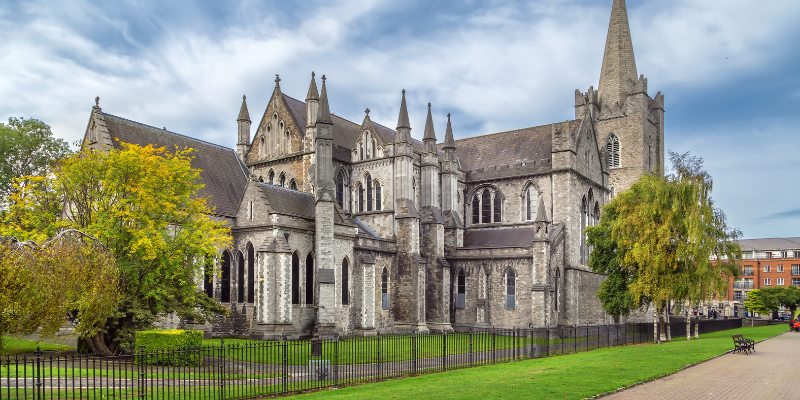 St. Patrick's Cathedral in New York, is characterized by its large structure and distinctive steeple reaching upward.