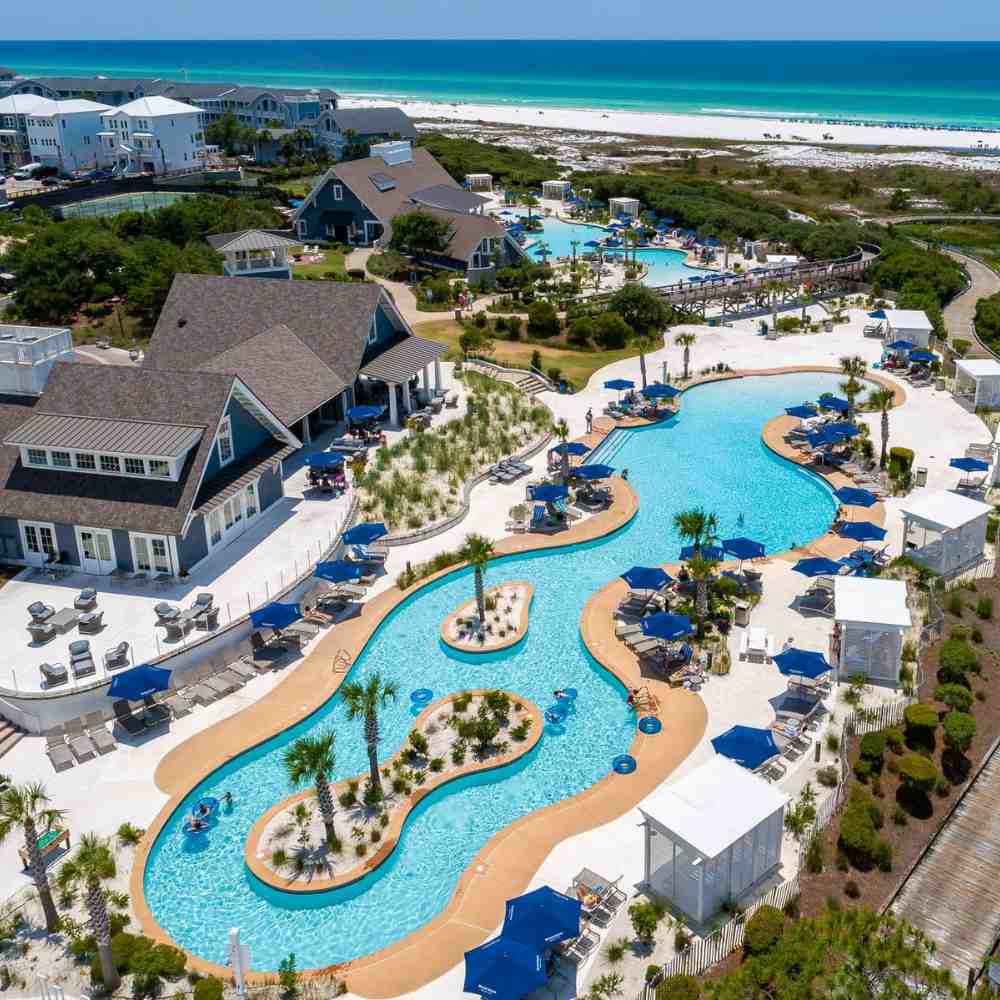 Aerial view of the resort with a meandering pool and cabanas near the ocean in Destin, Florida.