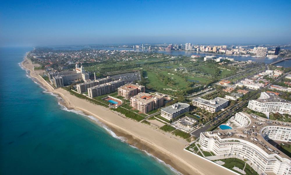 Stunning aerial shot of West Palm Beach, highlighting the beautiful beach and the expansive ocean in Miami.