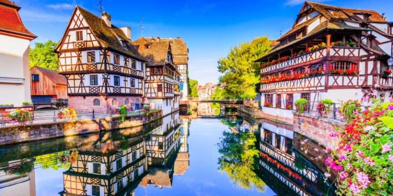 Scenic Colmar in Alsace, France, featuring vibrant architecture and serene waterways, embodying the city's enchanting beauty.