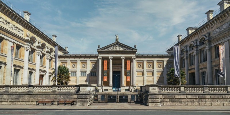 The Ashmolean Museum features an impressive large building with multiple striking columns enhancing its architectural beauty.