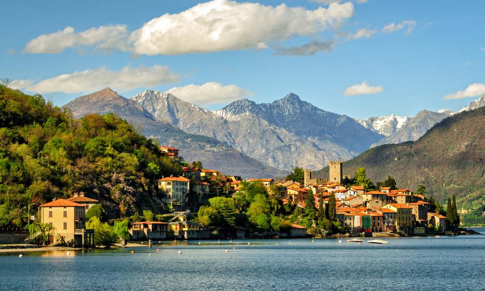 A picturesque small town by Lake Como, Italy, nestled among majestic mountains, reflecting serene beauty.