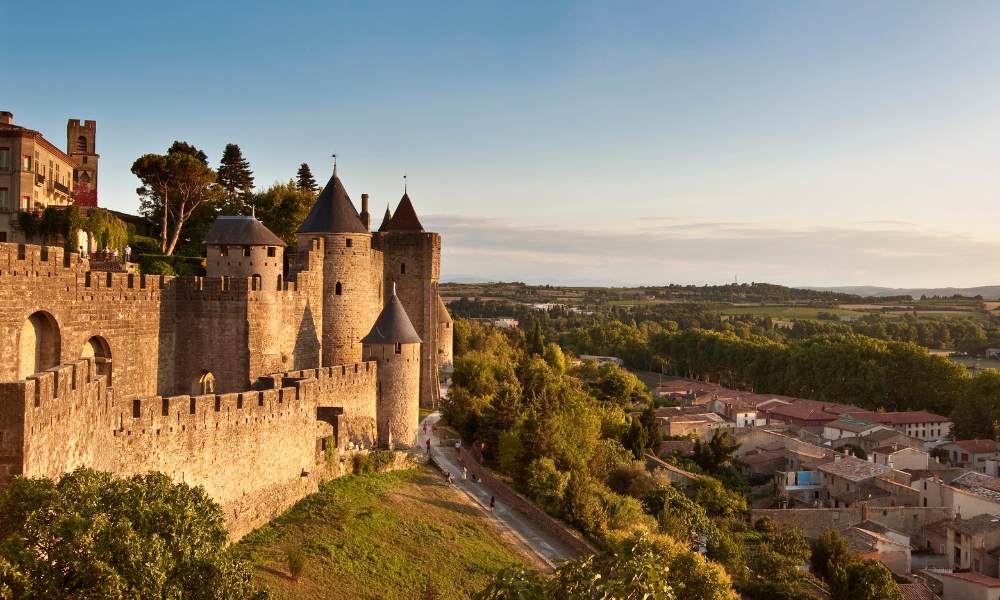 Carcassonne's iconic castle rises above the town, blending history and beauty in a picturesque landscape.