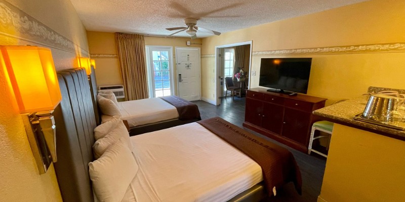 Cozy deluxe family suite with two beds and a TV, ideal for family relaxation and entertainment.