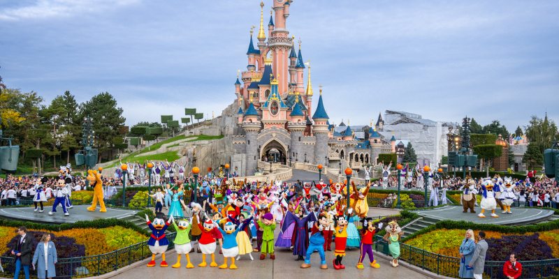 Disneyland Paris celebrates its 50th anniversary with festive decorations and joyful visitors enjoying the magical atmosphere.