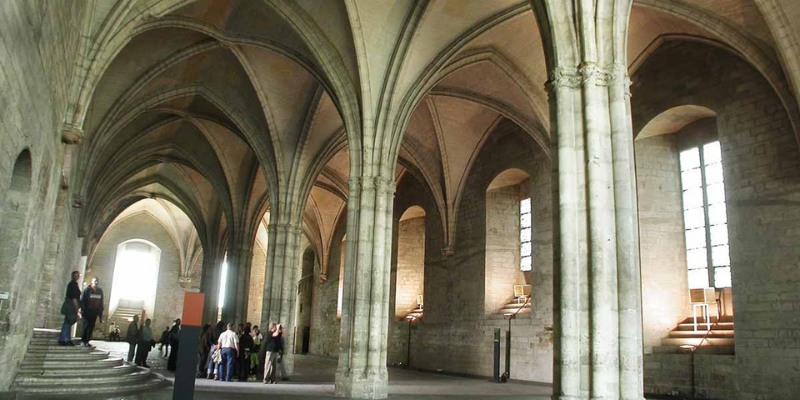 Interior view of the Grand Chapel showcasing elegant arches and towering pillars in a majestic cathedral setting.