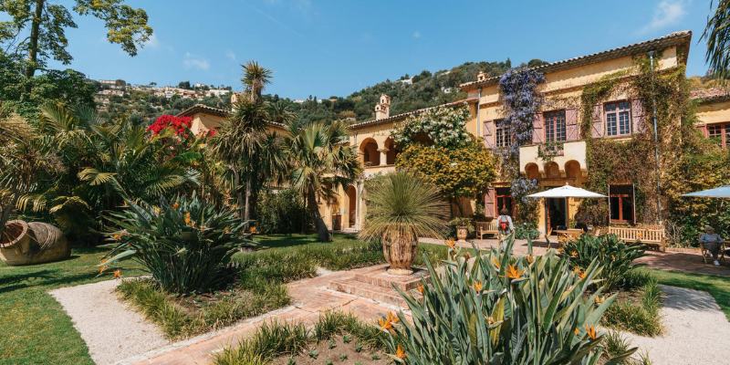 An elegant villa with a flourishing garden and inviting pool, highlighting the charm of Menton's Gardens.