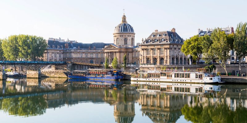 Musée d'Orsay and Seine reflections showcase historic architecture and moored boats.