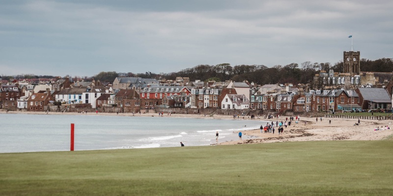 North Berwick beach features soft sands and buildings in the background, creating a picturesque coastal scene.