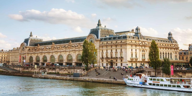 The Seine River in Paris, with the Orsay Museum visible along its banks, showcasing the city's iconic architecture.