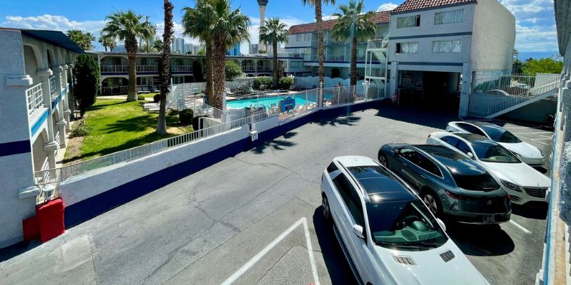 Parking area of the Shalimar Hotel, featuring multiple cars and clear signage in a well-maintained lot in Las Vegas.