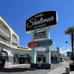 Sign for Shalimar Hotel of Las Vegas at the street corner, showcasing the hotel's name prominently.