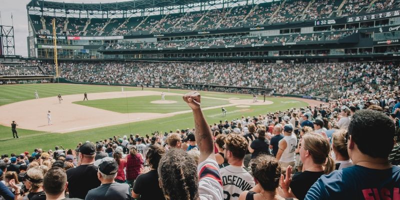 A diverse crowd of enthusiastic fans at a baseball game, immersed in the excitement of the event and the lively atmosphere.