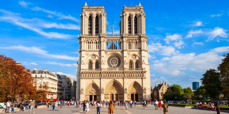 Stunning view of the towers of Notre-Dame Cathedral in Paris, showcasing its iconic Gothic architecture against a clear sky.