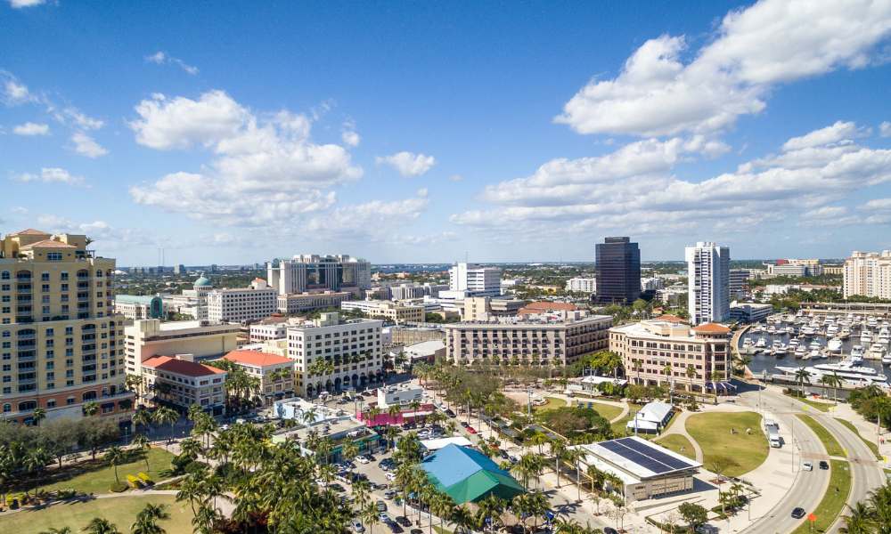 Aerial view of Miami showcasing the skyline, with West Palm Beach visible in the distance.