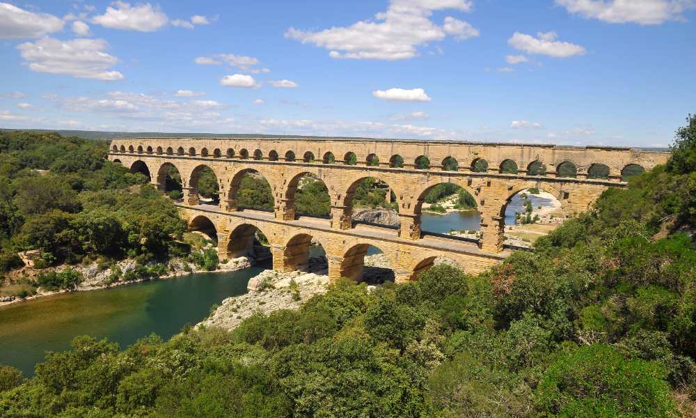 Historic Pont du Gard bridge in France, showcasing ancient Roman engineering and stunning natural surroundings.