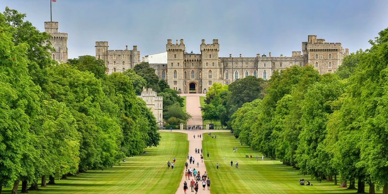 Scenic view of the grounds of Windsor Castle, showcasing lush greenery and historic architecture in England.