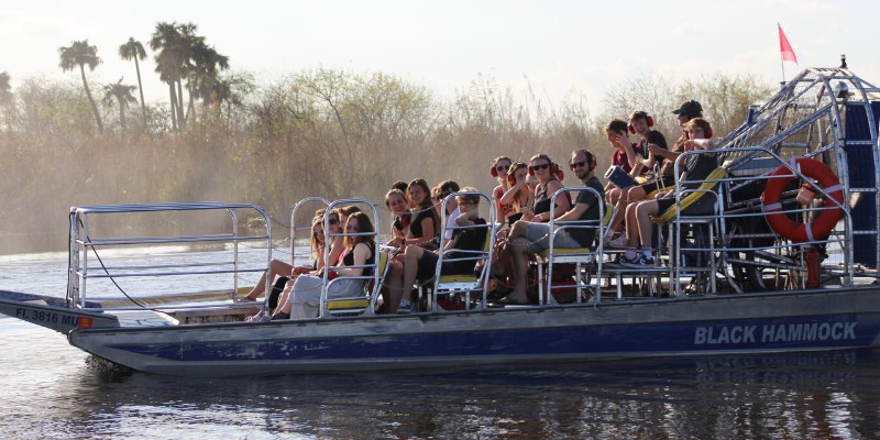 A group of people enjoying a boat ride on the water at Black Hammock Airboat Adventures.