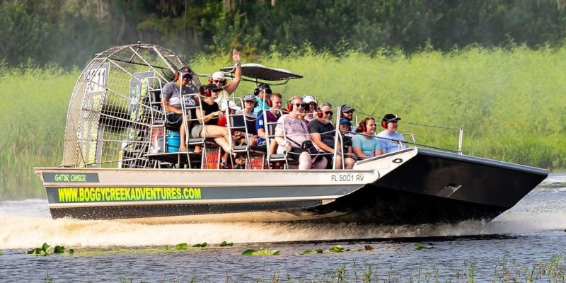 People experiencing an exciting airboat ride together at Boggy Creek Airboat Adventures.