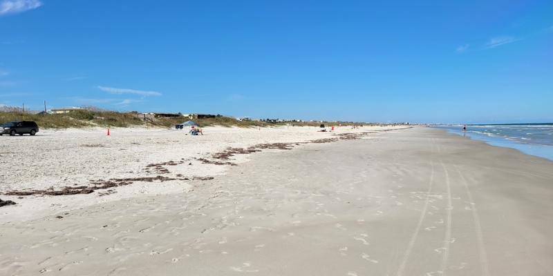 A sunny day at Butler Beach with sand and water creates a relaxing coastal atmosphere.