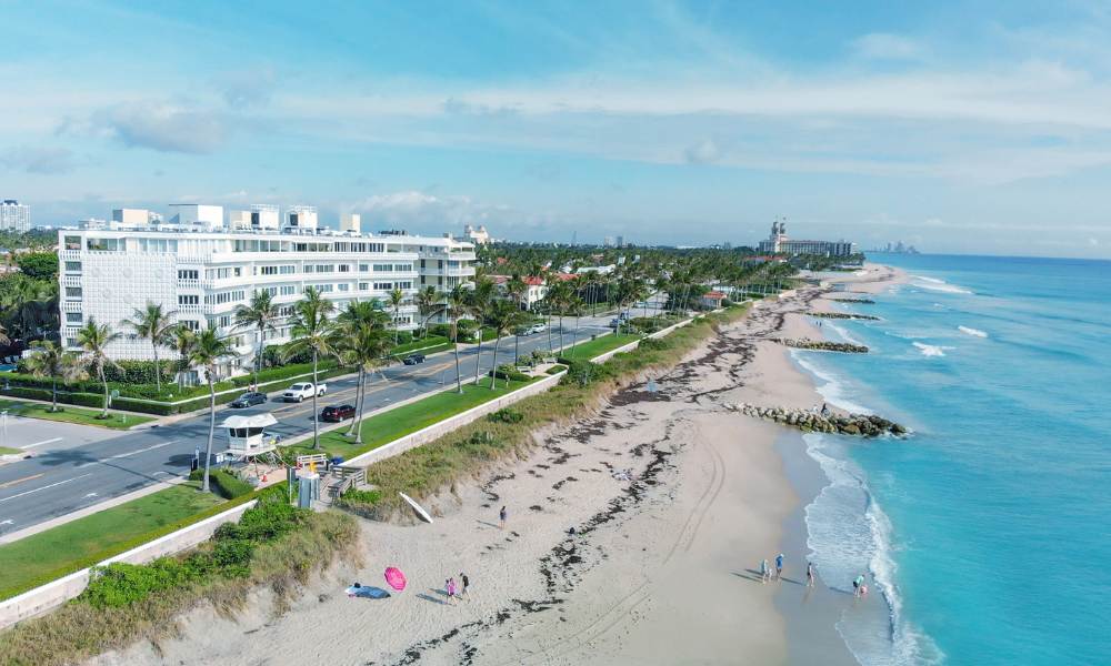 Overhead view of West Palm Beach Rentals, showcasing the coastline and clear ocean waters.