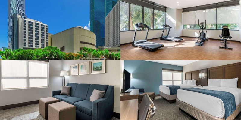 Stylish hotel room in Comfort Inn & Suites, showcasing a bed, couch, and desk, ideal for guests in Downtown Brickell.