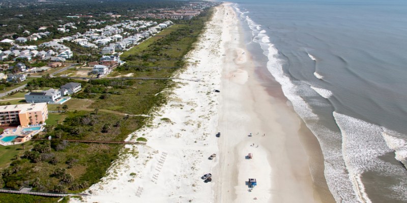 Bird's-eye view of Crescent Beach featuring the shoreline and the expansive ocean in the background.