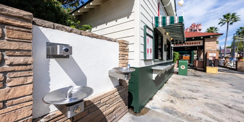 Free water fountain outside a building at Walt Disney World, inviting guests to stay hydrated during their visit.