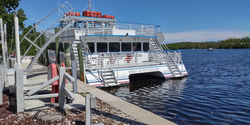 A glass bottom boat rests at the dock next to another dock in John Pennekamp Coral Reef State Park.