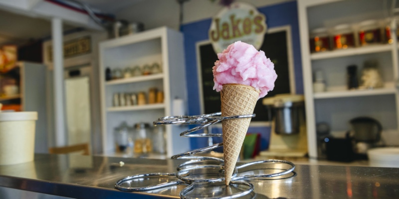 A colorful ice cream cone sits atop a counter at Jake’s Ice Cream in Florida, inviting customers to indulge.