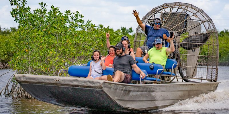 Tourists experience an airboat ride through the jungle with Jungle Erv’s Airboat Tours.