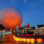 The Epcot ball shines brightly at night, surrounded by a serene atmosphere and colorful illumination.