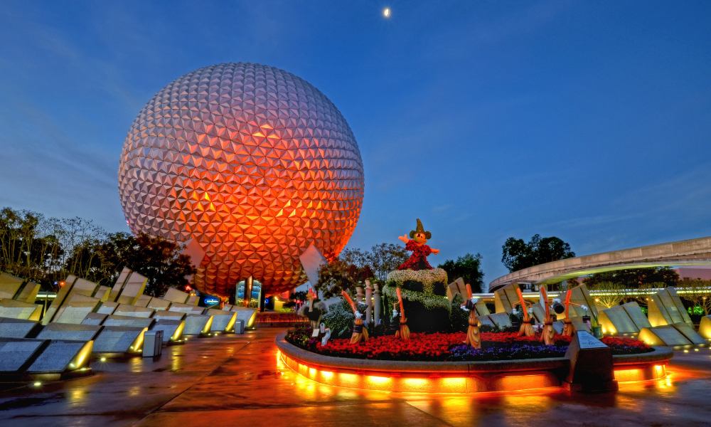 The Epcot ball shines brightly at night, surrounded by a serene atmosphere and colorful illumination.