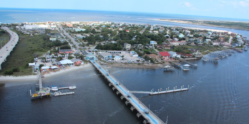 A charming bridge stretches over the water at Vilano Beach, blending seamlessly with the scenic coastal environment.